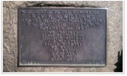 Bronze dedication tablet mounted on stone, listing the ten pioneers who organized the church on 22 November 1857.